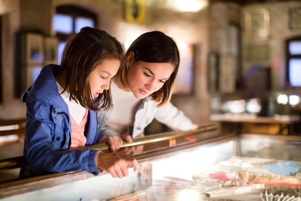 Two people looking at a display case in one of the museums found near Gatlinburg.