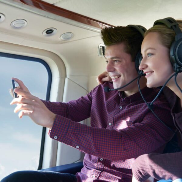 A couple taking in the views on one of the best helicopter rides over Gatlinburg.