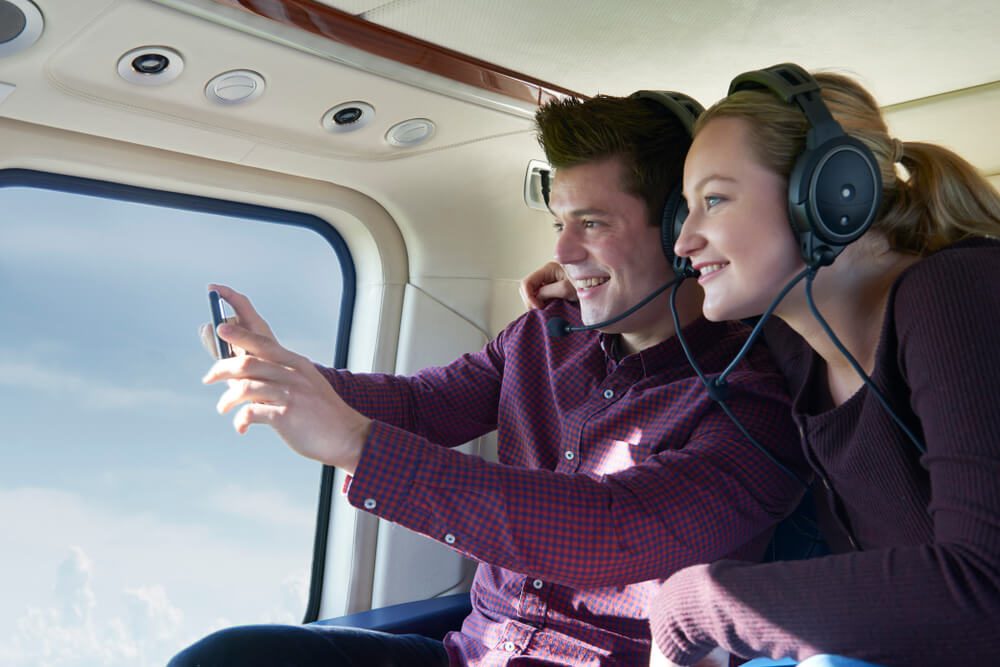 A couple taking in the views on one of the best helicopter rides over Gatlinburg.