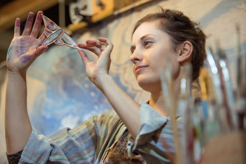 A member of the Gatlinburg Arts and Crafts community looking at her work.