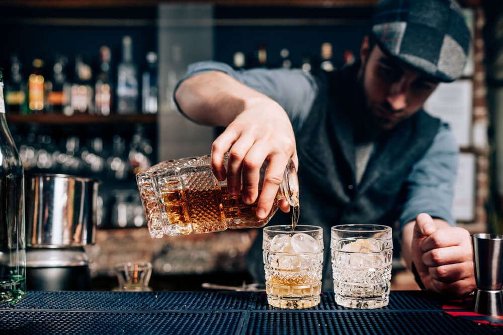 A bartender pouring a drink at one of the distilleries in Gatlinburg.