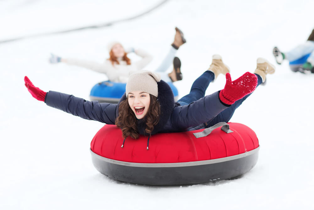 A group of people snow tubing at Ober Mountain.
