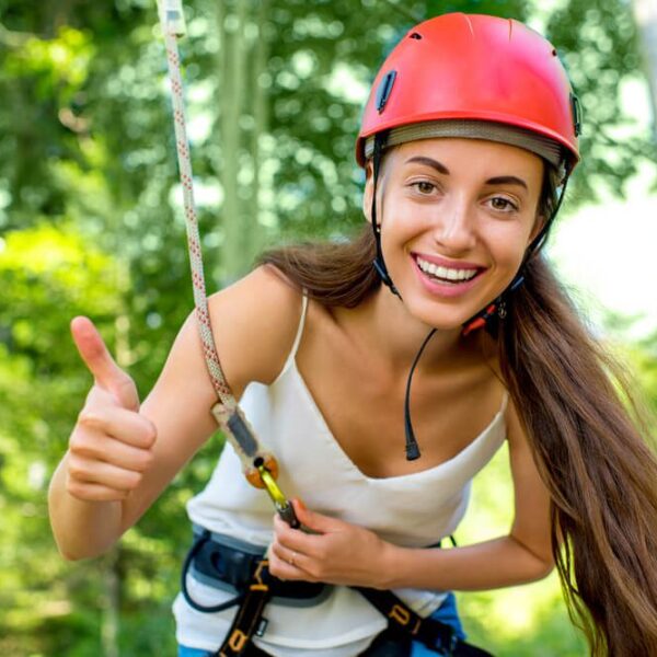 A woman getting ready to go down the zipline, one of the rides at Anakeesta.