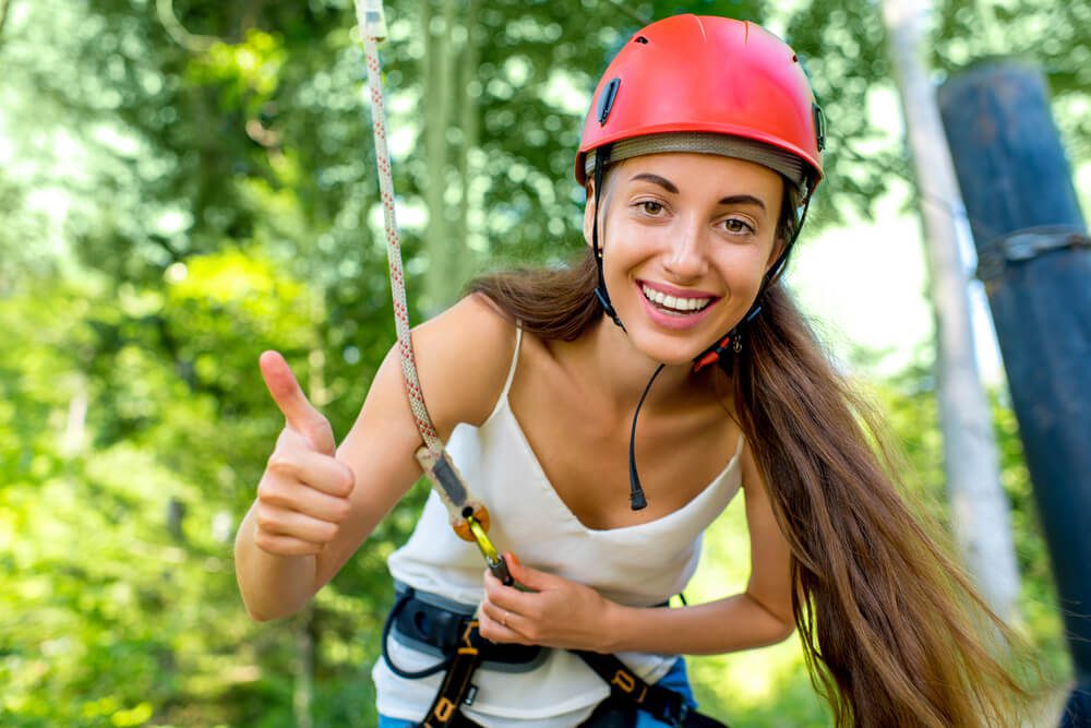 A woman getting ready to go down the zipline, one of the rides at Anakeesta.
