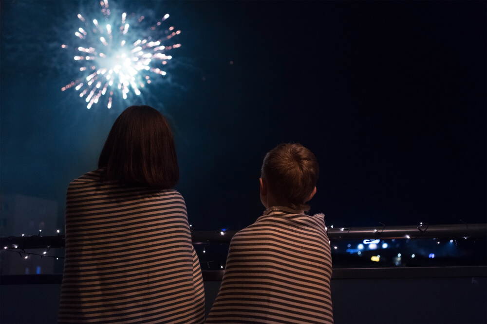 Two people watching fireworks during the Gatlinburg 4th of July celebration.