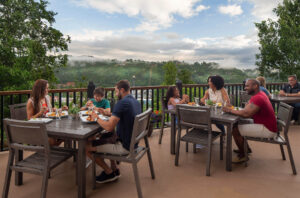 People eating outdoors at a Gatlinburg hotel near prime fishing spots.