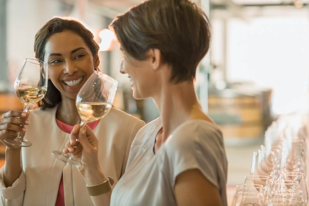 Two women with glasses of wine at wineries in Tennessee near Gatlinburg.
