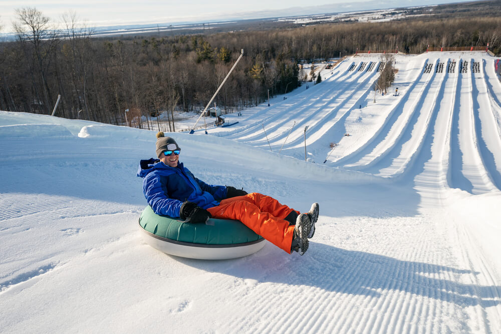 A person snowtubing on a Gatlinburg, TN, winter vacation.