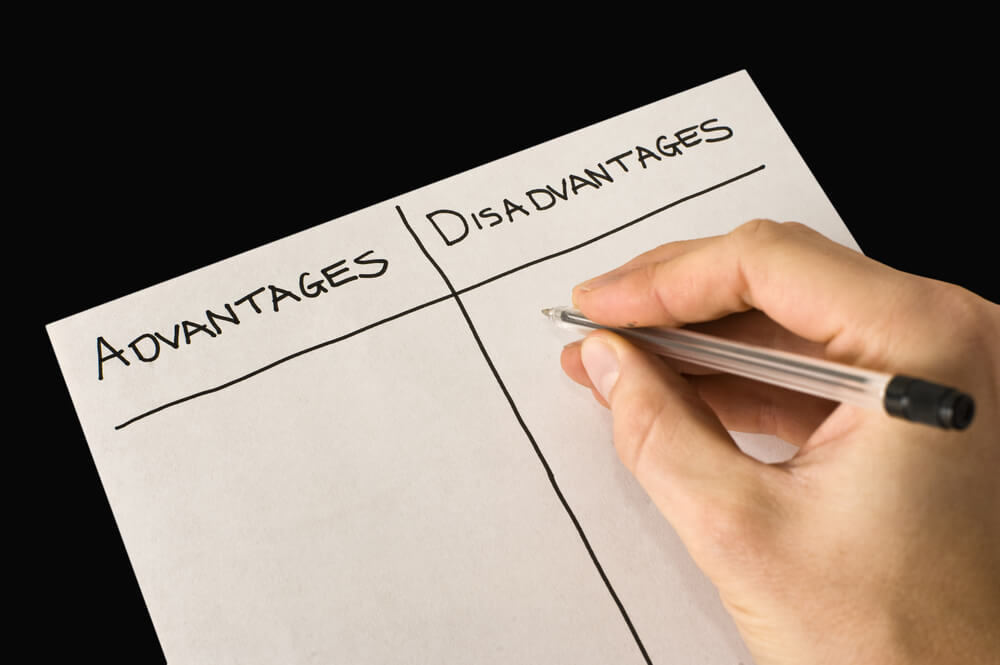 A person weighing Gatlinburg vs Pigeon Forge with a list of advantages and disadvantages.